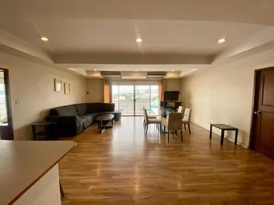 a living room with a couch and a table at ศรีย่าน เรสซิเดนซ์ Sriyan Residence in Dusit