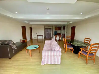 a living room with a couch and a table at ศรีย่าน เรสซิเดนซ์ Sriyan Residence in Dusit