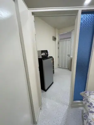 a hallway with a small refrigerator in a room at Sairin 1 bedroom BTS Udomsuk in Bangna