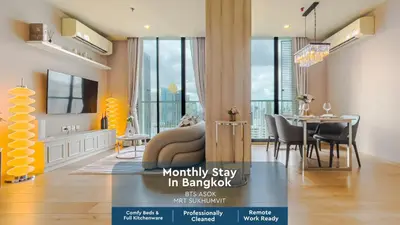 a living room with a couch and a dining room at CBD Living 2 BR ︱Prime Sukhumvit ︱Walk to BTS Asok & MRT SKV ︱UltraWi-Fi in Bangkok