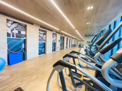 a gym with rows of treadmills at CBD Living 2 BR ︱Prime Sukhumvit ︱Walk to BTS Asok & MRT SKV ︱UltraWi-Fi in Bangkok