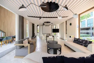 a living room with a couch and a table at Chambers cher ratchada ramintra in Ban Baen Phichit