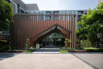a large building with a large entrance to it at Chambers cher ratchada ramintra in Ban Baen Phichit