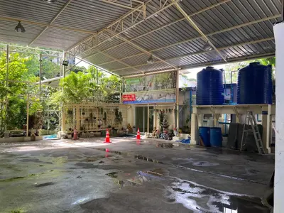 a building under construction with orange cones in the middle at UOKResort in Ban Khlong Yuan