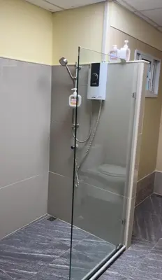 a shower stall with a toilet in a bathroom at UOKResort in Ban Khlong Yuan