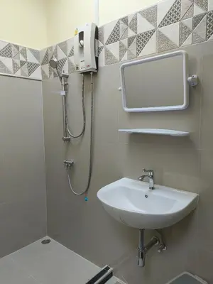 a bathroom with a sink and a shower at UOKResort in Ban Khlong Yuan