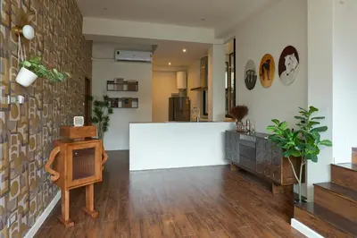 a living room with a white counter and wooden floors at 5loft Anti-Hotel, Silom, Bangkok in Bangkok