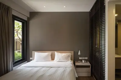 a bedroom with a large bed and a window at Bangkok Tryp in Bangkok