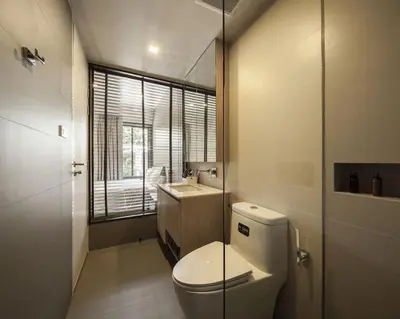 a bathroom with a toilet and a sink at Bangkok Tryp in Bangkok