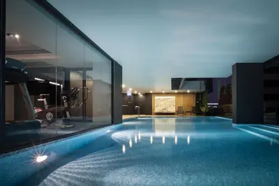a large swimming pool in the middle of a building at Bangkok Tryp in Bangkok