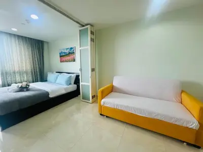 a bedroom with two beds and a mirror at The Station Condo1 in Bangkok