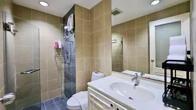 a bathroom with a sink and a shower and a toilet at The Station Condo1 in Bangkok