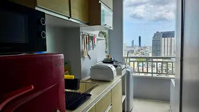 a kitchen with a view of a city from a window at The Station Condo1 in Bangkok