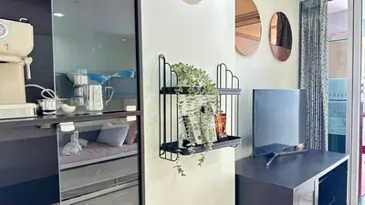 a kitchen with a shelf with plants in it at The Station Condo1 in Bangkok