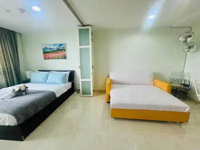 a bedroom with two beds and a shelf at The Station Condo1 in Bangkok