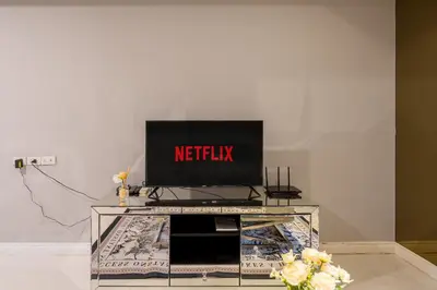 a television sitting on top of a entertainment center at State tower High Floor City View Lovely Unit in Bangkok