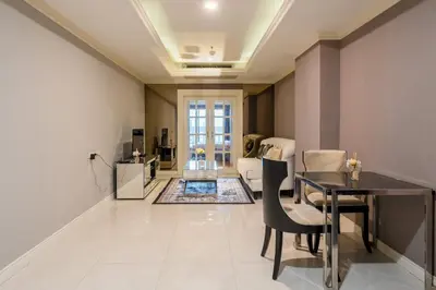 a living room with a table and a dining room at State tower High Floor City View Lovely Unit in Bangkok