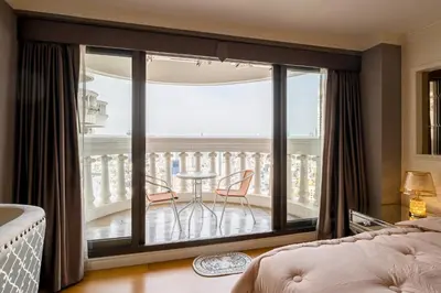 a bedroom with a balcony with a table and chairs at State tower High Floor City View Lovely Unit in Bangkok