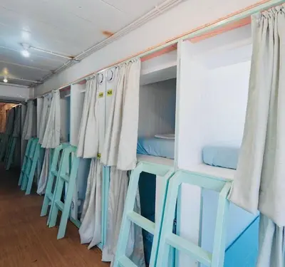 a row of bunk beds on a cruise ship at The Hide Out Rambuttri Hostel in Bang Bua Thong Railway Station