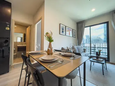 a living room with a dining room table with chairs at Luxury 2BR︱Fast WiFi︱Walk to Central & MRT Rama 9 in Bangkok