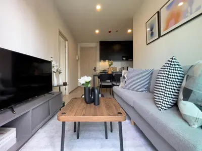 a living room with a couch and a coffee table at Luxury 2BR︱Fast WiFi︱Walk to Central & MRT Rama 9 in Bangkok