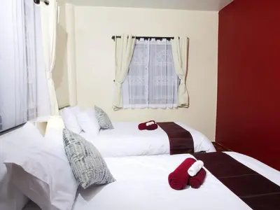 two beds in a bedroom with red towels on them at Cozy House 2BR BTS Ekkamai in Bangkok