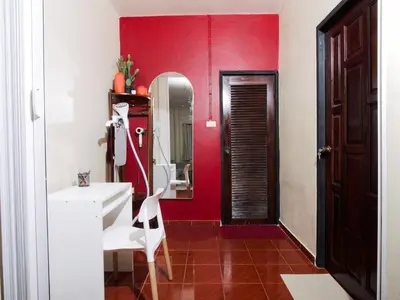 a red bathroom with a sink and a mirror at Cozy House 2BR BTS Ekkamai in Bangkok