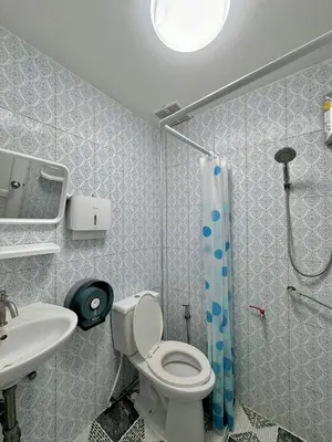 a bathroom with a toilet and a sink and a shower at Baan Alisa 12 in Nonthaburi