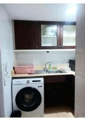 a kitchen with a washing machine and a sink at Omni Tower Nana- Fully Furnished Apartments Bangkok in Bangkok