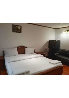 a bedroom with a bed and a couch in it at Omni Tower Nana- Fully Furnished Apartments Bangkok in Bangkok
