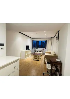 a kitchen and living room with a couch and a table at Omni Tower Nana- Fully Furnished Apartments Bangkok in Bangkok