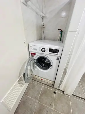 a washer and dryer in a small room at Omni Tower Nana- Fully Furnished Apartments Bangkok in Bangkok