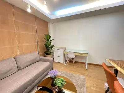 a living room with a couch and a table at Modern 5-Bedroom Townhome near MRT and Local Charm in Bangkok