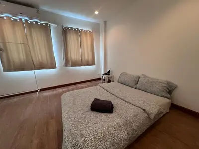 a bedroom with a large bed with a bag on it at Above Heaven - 4BR for 12 Pax near MRT Ratchadapisek in Bangkok