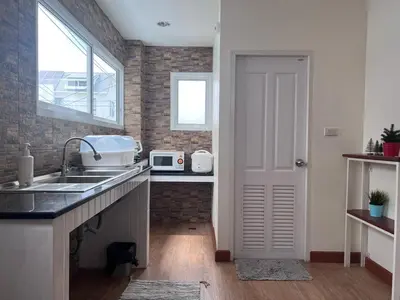 a kitchen with a sink and a window at Above Heaven - 4BR for 12 Pax near MRT Ratchadapisek in Bangkok