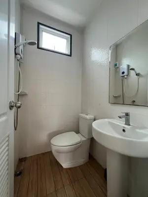 a bathroom with a toilet and a sink and a window at Above Heaven - 4BR for 12 Pax near MRT Ratchadapisek in Bangkok