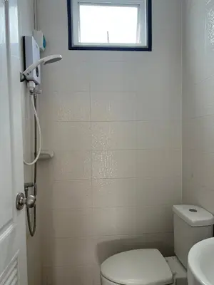 a small bathroom with a toilet and a window at Above Heaven - 4BR for 12 Pax near MRT Ratchadapisek in Bangkok