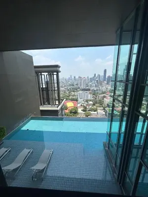 a swimming pool with a view of a city at 1BR Thonglor BTS InfinityPool overlooking city in Bangkok