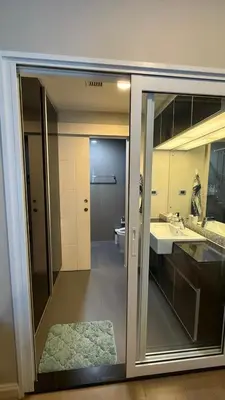 a bathroom with a sink and a mirror at 1BR Thonglor BTS InfinityPool overlooking city in Bangkok