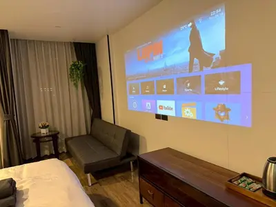 a room with a bed and a large screen on the wall at Cozy Mini Theatre - Victory Monument - 3 pax in Bangkok