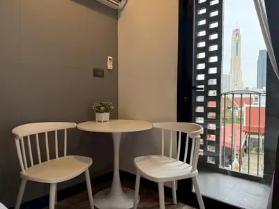 a table and two chairs in a room with a window at Cozy Mini Theatre - Victory Monument - 3 pax in Bangkok