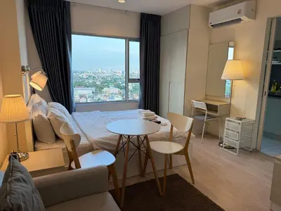 a living room with a bed and a table and chairs at Cozy5Living in Bangkok 60m to MRT near chatuchank in Ban Bang Khwang