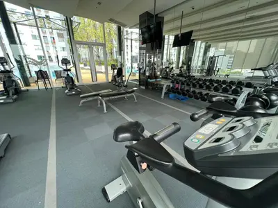 a gym with several treadmills and machines in it at Cozy5Living in Bangkok 60m to MRT near chatuchank in Ban Bang Khwang