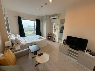 a bedroom with a bed and a tv and a couch at Cozy7 Living in Bangkok60 m to MRTnear chatuchank in Ban Bang Khwang