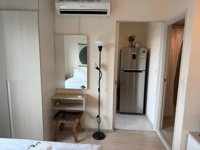 a small room with a refrigerator and a mirror at Cozy7 Living in Bangkok60 m to MRTnear chatuchank in Ban Bang Khwang