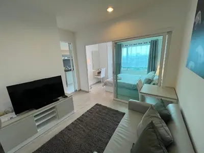 a living room with a couch and a flat screen tv at Cozy6 Living in Bangkok 60m to MRT near chatuchank in Ban Bang Khwang