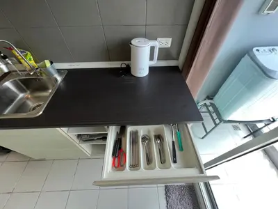 a small kitchen with a counter with scissors and a sink at Cozy6 Living in Bangkok 60m to MRT near chatuchank in Ban Bang Khwang