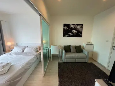 a bedroom with a bed and a chair and a mirror at Cozy6 Living in Bangkok 60m to MRT near chatuchank in Ban Bang Khwang