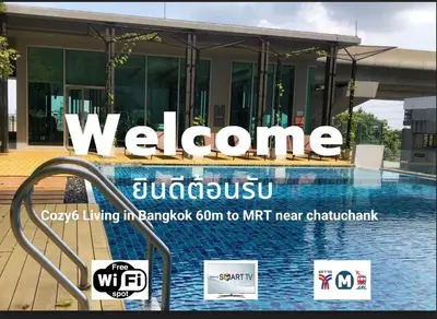 a sign that reads welcome to jumeu with a swimming pool at Cozy6 Living in Bangkok 60m to MRT near chatuchank in Ban Bang Khwang