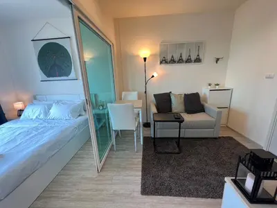a bedroom with a mirror and a bed and a chair at Cozy8Living in Bangkok 60mto MRT in Ban Bang Khwang